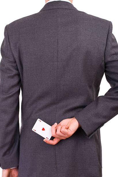 istock Businessman holding playing card behind his back. 178854732