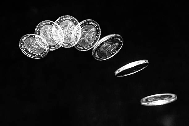 Coin toss Stroboscopic effect created using flash capturing the motion of a coin as it is being tossed in the air temporal aliasing stock pictures, royalty-free photos & images