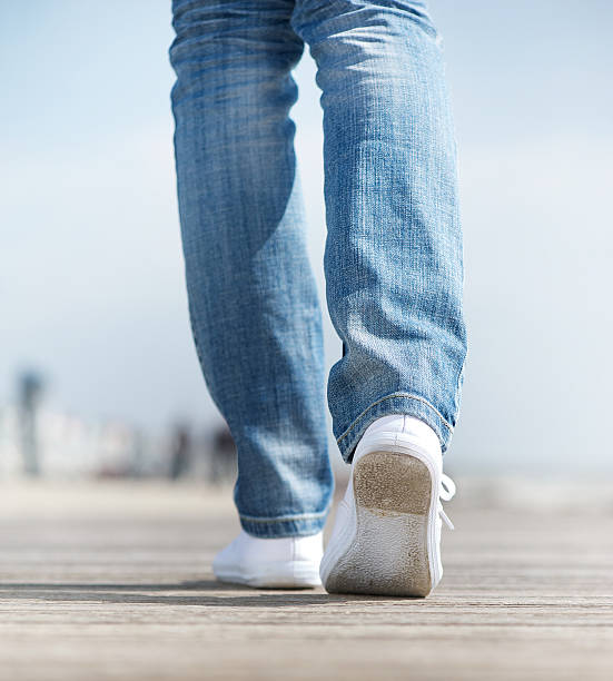 istock Woman walking outdoors in comfortable white shoes 178856484