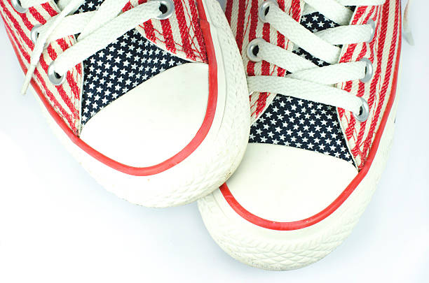 Pair of shoes with american stars and stripes decoration Pair of shoes with american stars and stripes decoration from above usa flag shoes stock pictures, royalty-free photos & images