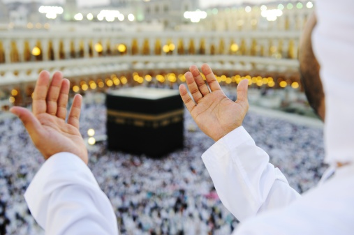 Muslim praying at Mekkah with hands up