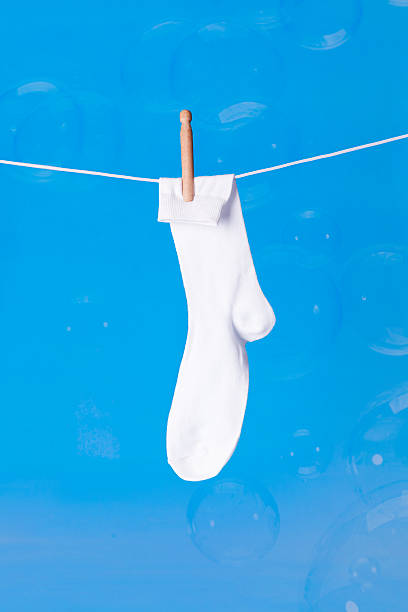 istock White sock on washing line with bubbles blue background 178857994