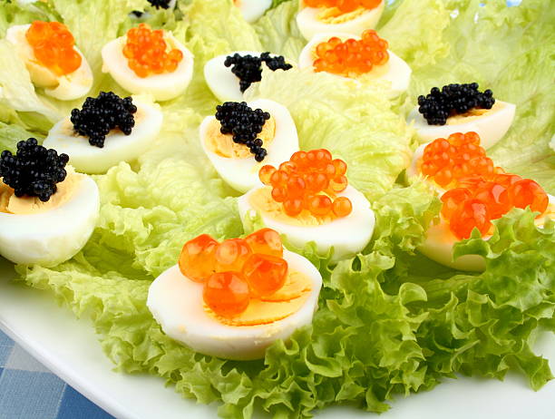 Quail eggs topped with salmon, trout and sturgeon caviar, close up
