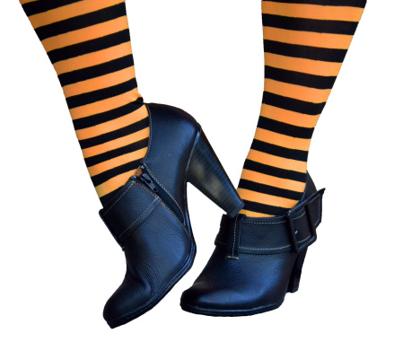 Halloween Witch feet with black boot type shoes with black and orange striped stockings