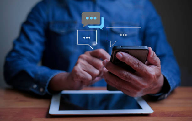 istock People using smartphone typing Live chat chatting and social networking and  chatting conversation and working at home in chat box icons pop up. Social media marketing technology concept. 1788617509