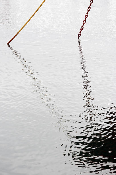 istock Reflections of an anchored ship and a rope 178861854