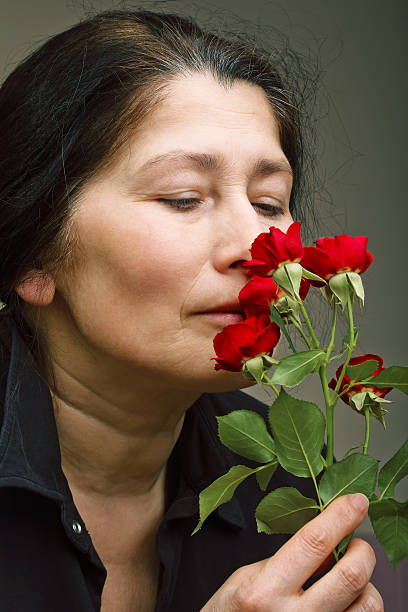 istock Mature woman with roses 178862961