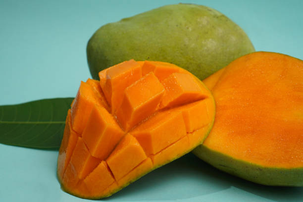 istock fresh mango fruit with cube slice with yellow flesh inside isolated on cutting board blue background contain vitamin C 1788633319