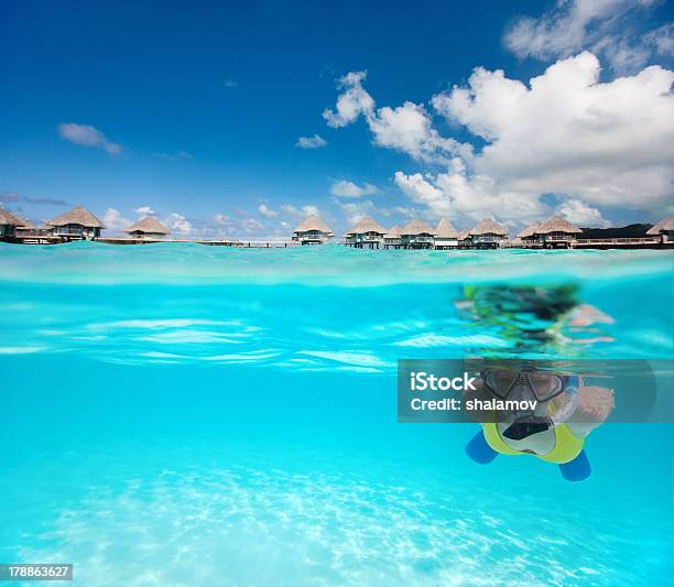 Under And Above Water Photo With Woman Snorkeling Stock Photo - Download Image Now - Maldives, Snorkeling, Tourism