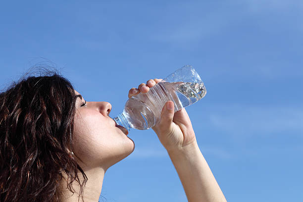 istock Profile of a beautiful woman drinking water from  plastic bottle 178863786