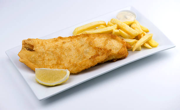istock Battered fish and chips with lemon wedge, tartar sauce 178863906
