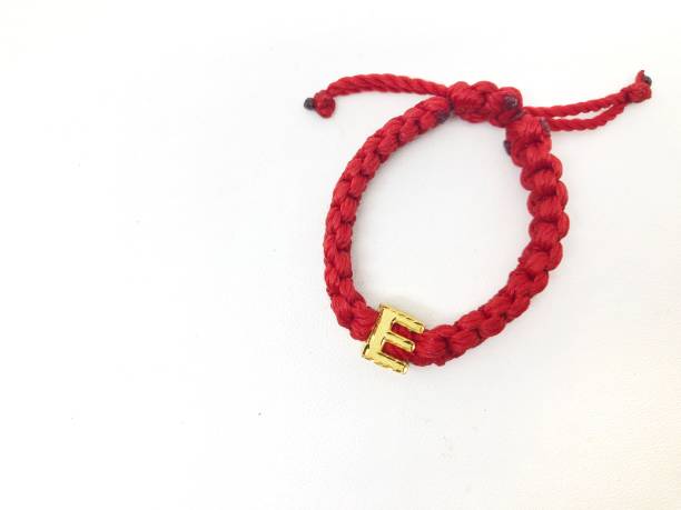 istock Red handmade knitted bracelet with gold letter E accessories 1788641524