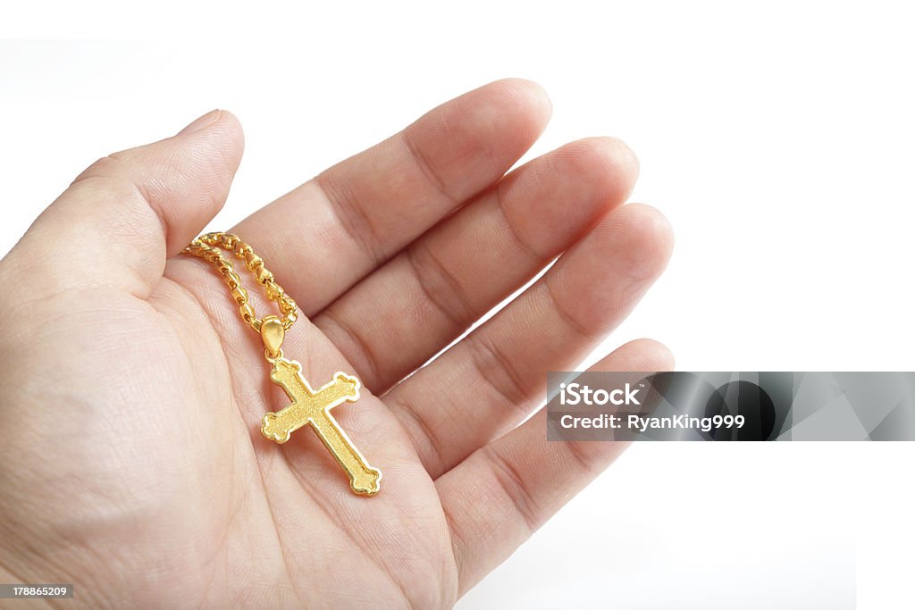 Hand hold golden cross necklace Hand hold with golden cross necklace isolated on white backgroundModel: Gold - Metal Stock Photo