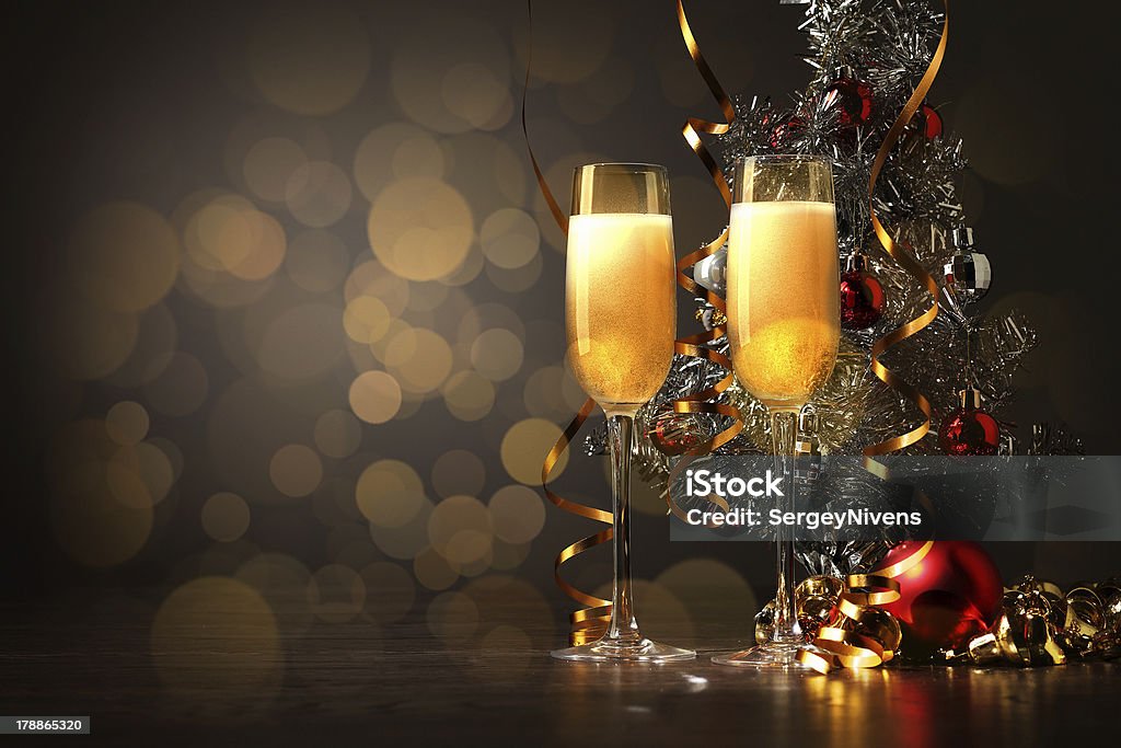 Glasses of champagne at new year party Two champagne glasses ready to bring in the New Year Anniversary Stock Photo