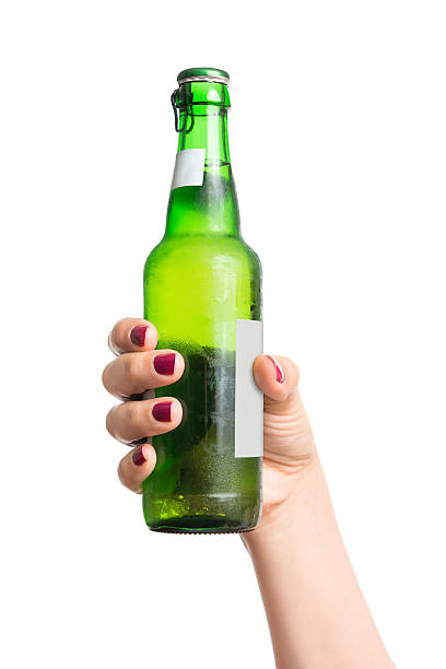 Bottle of beer in hand stock photo