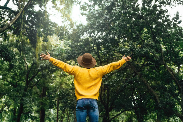 A Hiker Young man breathing deep fresh air outdoor.
