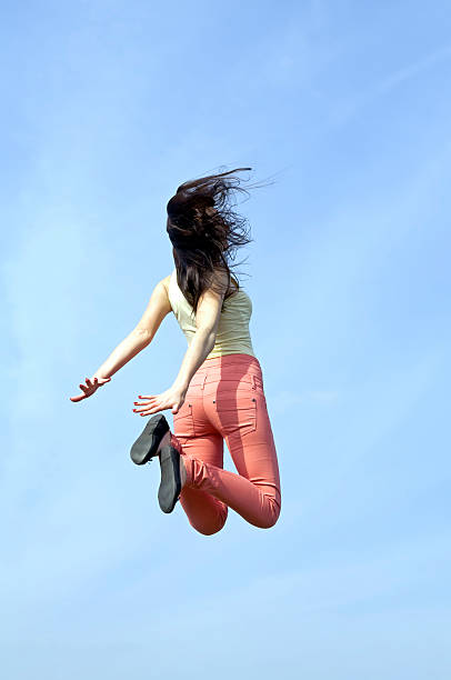 istock rear view of joyful leap 178869633