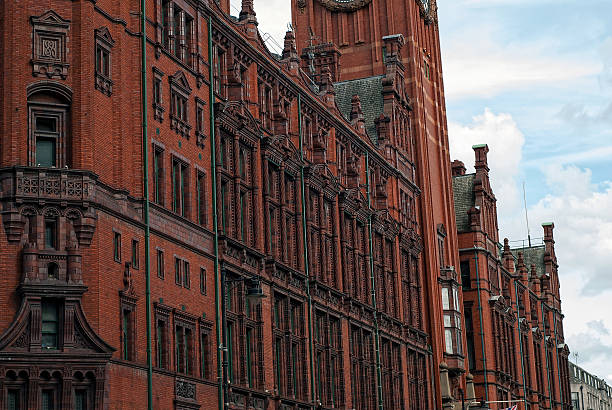 A detail of an historical building in the heart of Manchester city center. This red brick and terracotta building was built in 1891-1895 by Alfred Waterhouse and is known as Refuge Assurance Building or Refuge Building. Standing at the corner of Oxford Street and Whitworth Street, the building is now used by the four star Palace Hotel.