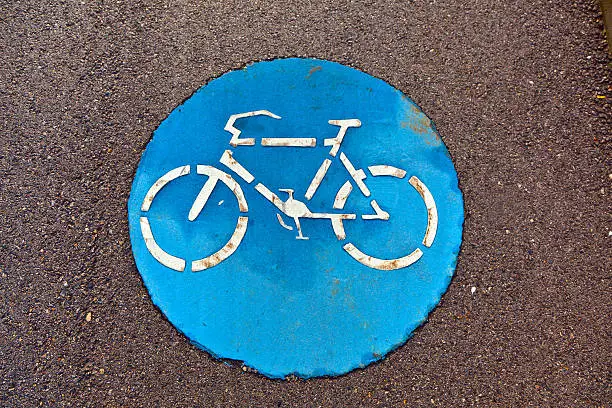 blue symbol for bikelane on asphalt