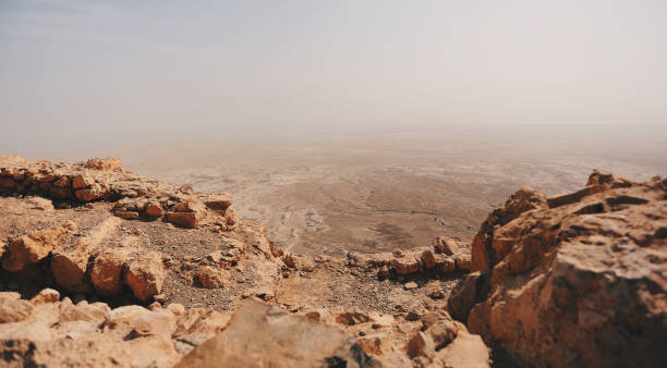 Atop of Masada, looking down into Israeli desert Atop of Masada, looking down into Israeli desert dead sea scrolls stock pictures, royalty-free photos & images