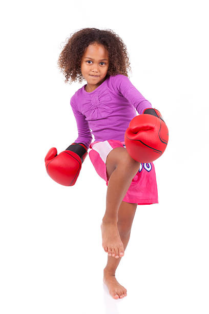 Little muay thai boxing girl using her knee stock photo