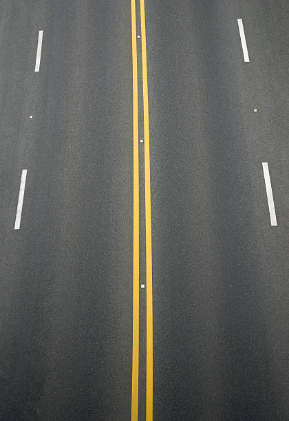 istock double yellow line and white lines divider on blacktop 178872521
