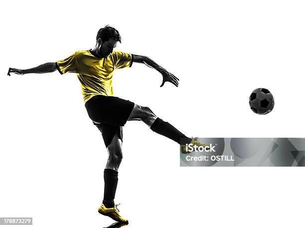 Silhouette Of A Young Brazilian Soccer Player Kicking A Ball Stock Photo - Download Image Now