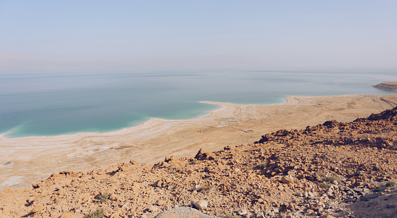 Dead Sea coastline with rocks in foreground