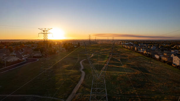 A power line pole with a cloudy sky in the background. The sky is dark and gloomy, and the power lines are bare