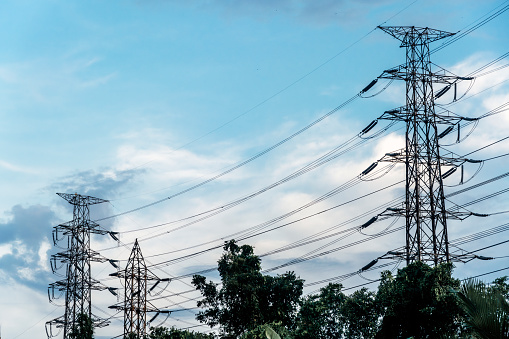 Big electrical towers of high tension for the distribution of electricity on a blue sky in Bangkok,Thailand
