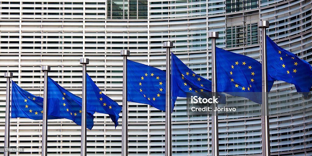 A row of European flags in front of a building European flags in front of the Berlaymont building, headquarters of the European commission in Brussels. European Union Stock Photo