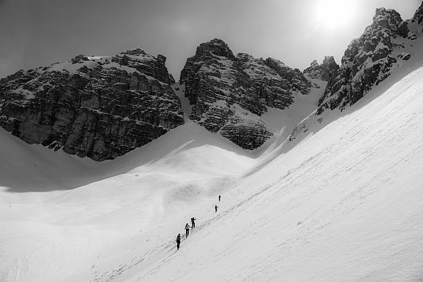 istock Group ski touring into couloir 178875186