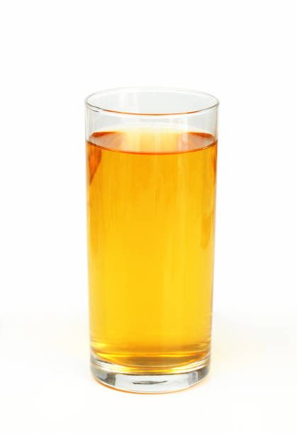 Glass of apple juice on white background Glass of apple juice - studio shot apple juice photos stock pictures, royalty-free photos & images