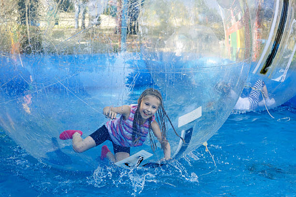 Girl on roller coaster zorbing Zorbing - Agility and Speed zorbing stock pictures, royalty-free photos & images