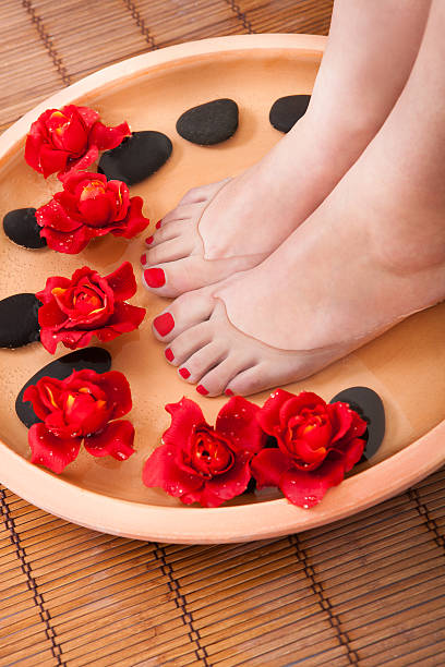 Female Feet Getting Aroma Therapy Close-up Of Female Feet Getting Spa Aroma Therapy reflexology stone massaging human foot stock pictures, royalty-free photos & images