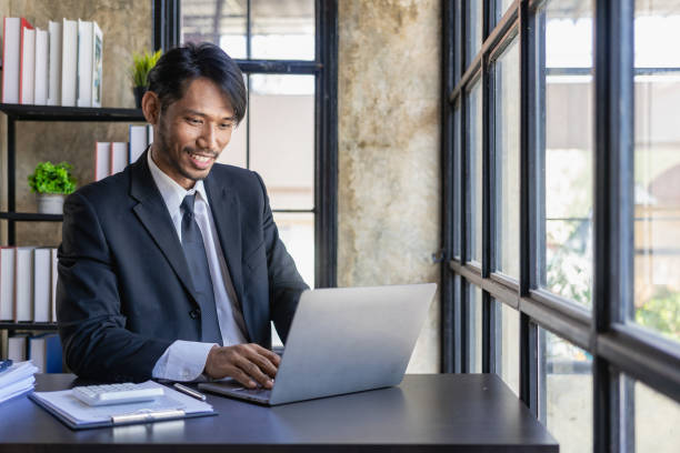 istock Young African man working with analyst sitting in beautiful workplace with computer, laptop and documents, checking financial reports. 1788759569
