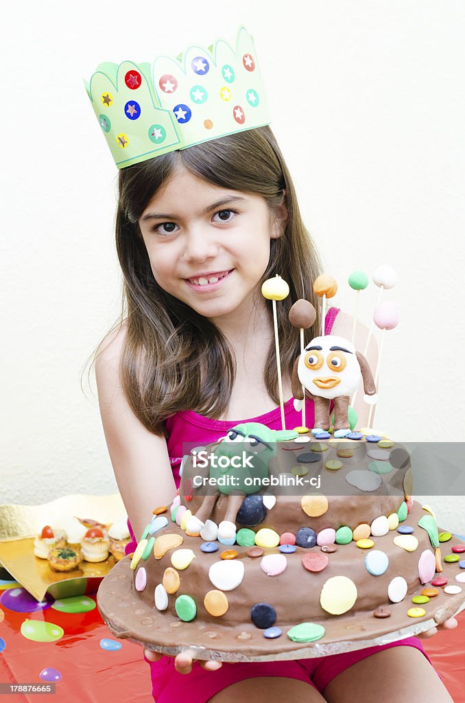 Cute Girl Holding a Cake Cute girl holding a cake at her birthday Anniversary Stock Photo