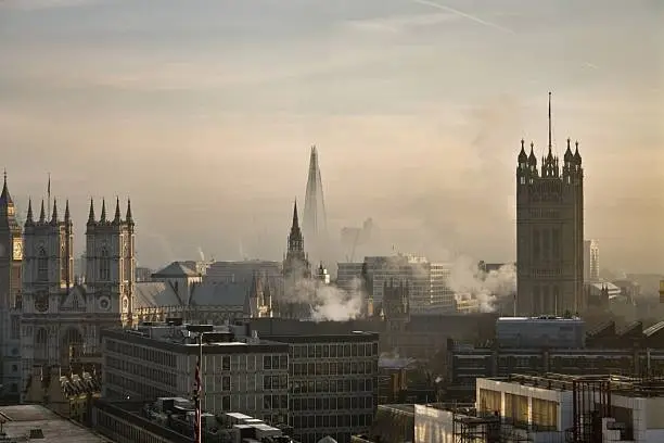 Landscape photo looking out over the buildings, to the Shard, Westminster and Big Ben - steam rising form the buildings.