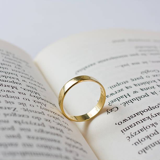 istock Close up of wedding ring lying on an open book 178876909