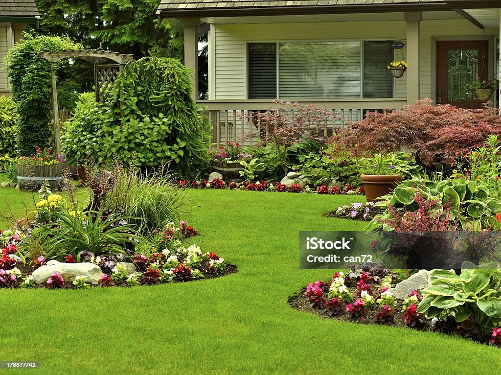 Manicured Yard A beautifully arranged flower garden and residential yard. Yard - Grounds Stock Photo