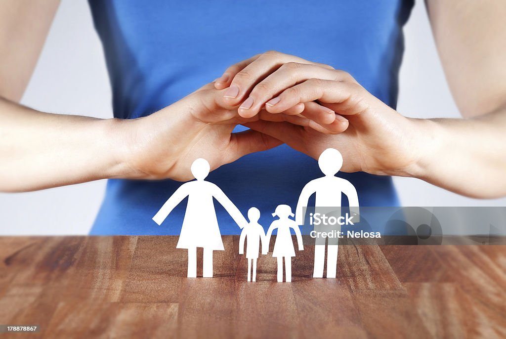 protecting a family hands protecting a white paper chain family Begging - Social Issue Stock Photo