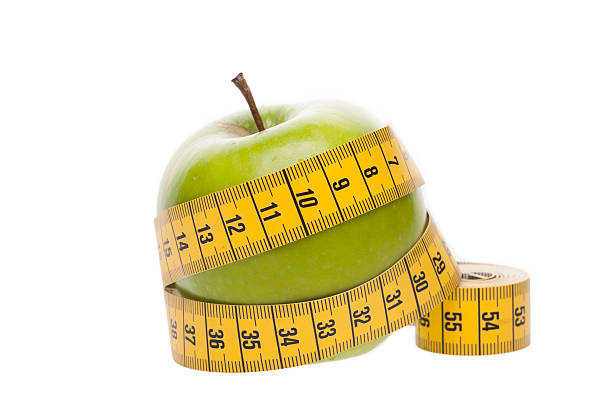 istock Dieting concept Green apple with  tape measure 178879142