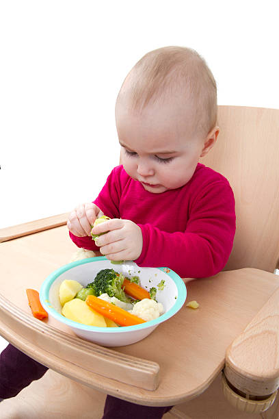 istock young child eating in high chair 178880106
