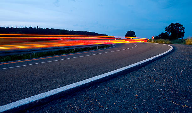 istock light beams from passing cars after sunset 178880934
