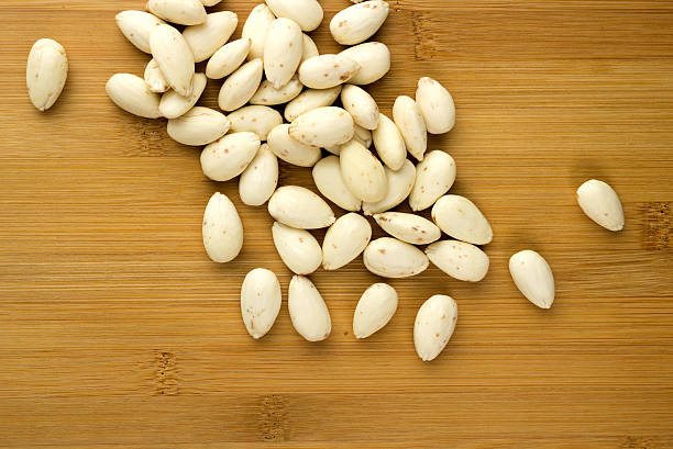 istock Blanched almonds scattered on a wooden board 178881439