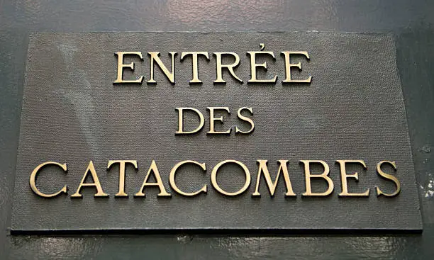 A sign in Paris announcing the entrance to the Catacombs, an underground cemetery.