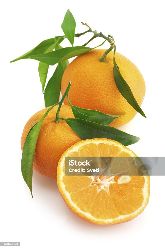 Fresh tangerines Whole and cut fresh tangerines with leaves isolated on white background. Citrus Fruit Stock Photo