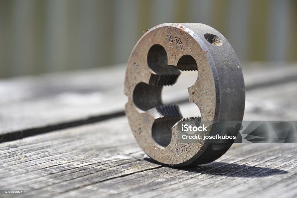 Industry The die cuts a thread on a preformed cylindrical rod, which creates a male threaded piece which functions like a bolt. Accuracy Stock Photo