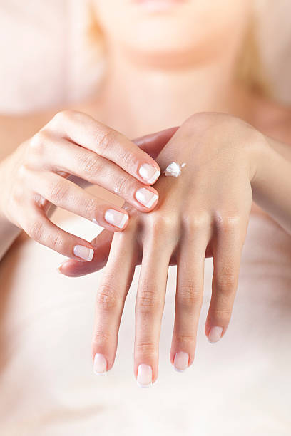 istock female applying cream on her hands 178885940