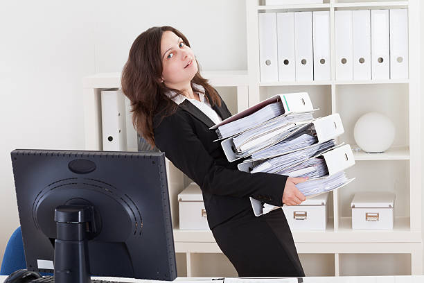 istock Businesswoman Carrying Stack Of Folders 178887000